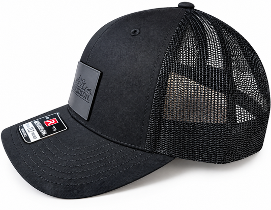 Black trucker hat with silver logo